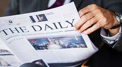 man looking at newspaper